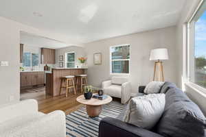 Living area with light wood finished floors, plenty of natural light, recessed lighting, and beamed ceiling