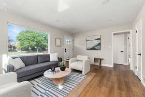 Living room with wood finished floors and recessed lighting
