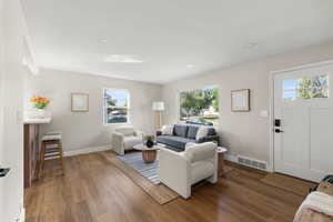 Living room featuring wood finished floors and recessed lighting