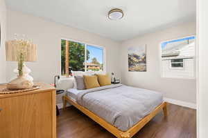 Bedroom featuring wood finished floors and baseboards