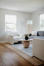 Living area with wood finished floors and baseboards