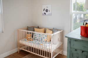 Bedroom featuring wood finished floors and baseboards