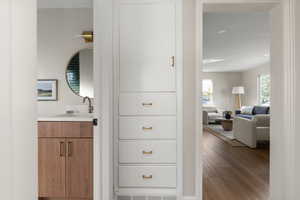 Corridor with wood finished floors and recessed lighting