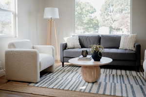 Living area with wood finished floors and baseboards