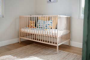 Bedroom featuring light wood finished floors and baseboards
