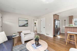 Living area with light wood-style flooring and baseboards