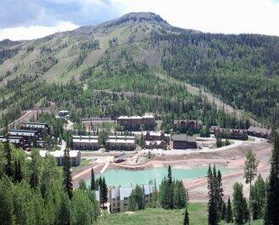 Mountain view with a large body of water and a heavily wooded area