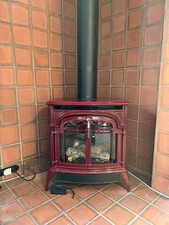 Detailed view of a wood stove and tile walls