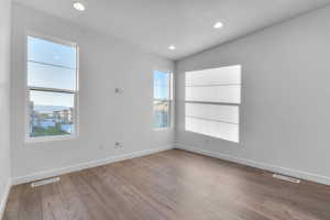 Spare room featuring recessed lighting, light wood-style floors, and a textured ceiling