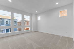 Unfurnished room featuring light colored carpet and recessed lighting