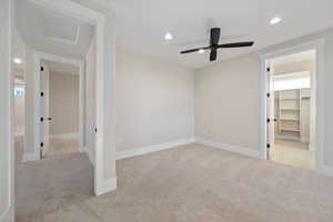 Unfurnished bedroom with recessed lighting, light carpet, attic access, a spacious closet, and ceiling fan