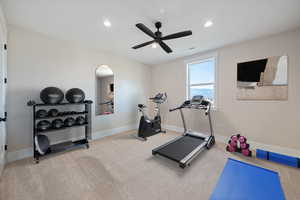 Workout area with light carpet, recessed lighting, and ceiling fan