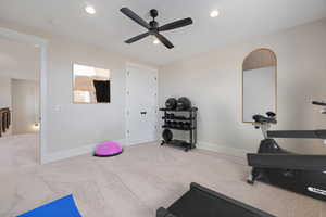 Exercise area with recessed lighting, carpet flooring, and a ceiling fan