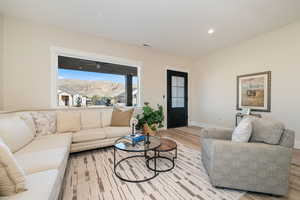 Living room featuring a mountain view, recessed lighting, and wood finished floors