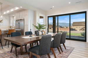 Dining space with a mountain view, plenty of natural light, recessed lighting, and light wood finished floors