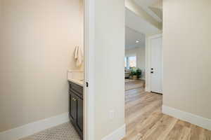 Corridor featuring baseboards and light wood-type flooring