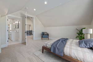 Carpeted bedroom featuring lofted ceiling and recessed lighting