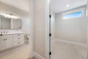 Bathroom with vanity and baseboards