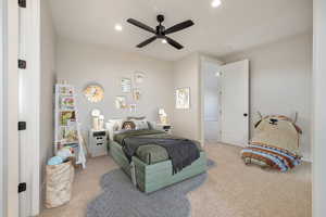 Carpeted bedroom featuring ceiling fan and recessed lighting