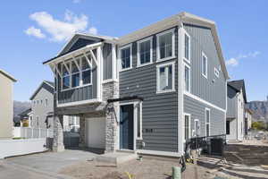 View of front of home with a mountain view, board and batten siding, and concrete driveway