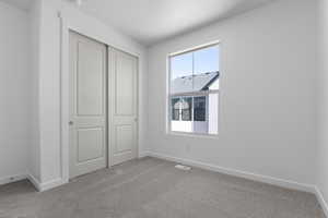 Unfurnished bedroom with carpet floors and a closet