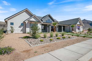 Modern inspired farmhouse featuring covered porch, a standing seam roof, a metal roof, and a mountain view