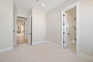 Unfurnished bedroom featuring light colored carpet and recessed lighting