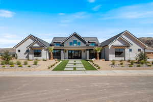 Modern inspired farmhouse with a porch, a standing seam roof, a metal roof, a mountain view, and french doors