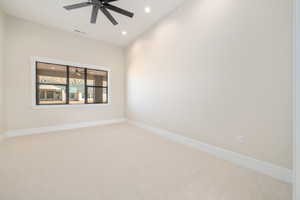 Carpeted empty room with recessed lighting and ceiling fan