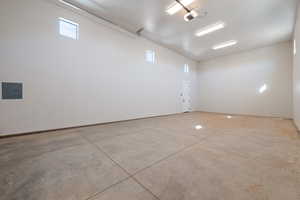 Garage featuring electric panel and a garage door opener