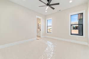 Unfurnished bedroom with light colored carpet, recessed lighting, ceiling fan, and ensuite bath