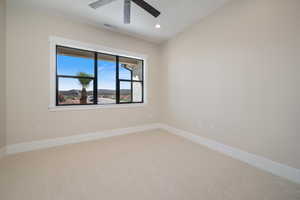 Empty room featuring carpet, a mountain view, and recessed lighting