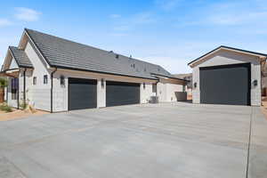 View of home's exterior featuring driveway, stucco siding, a garage, and a tile roof