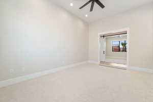 Unfurnished bedroom featuring a barn door, recessed lighting, light colored carpet, and ceiling fan
