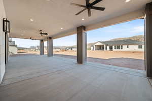 View of patio with ceiling fan and a mountain view