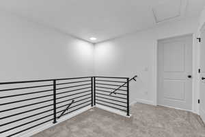 Empty room featuring light carpet