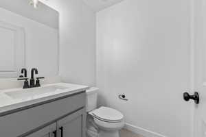 Half bath with vanity and light tile patterned floors