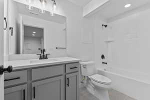 Full bath featuring light tile patterned floors, bathtub / shower combination, vanity, and recessed lighting