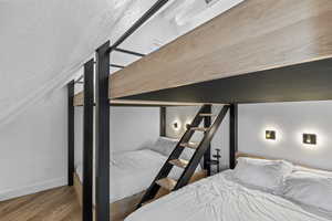 Bedroom with wood finished floors and a textured ceiling