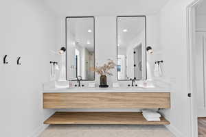 Full bathroom with double vanity, light tile patterned flooring, and recessed lighting