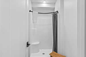 Full bathroom with a shower stall