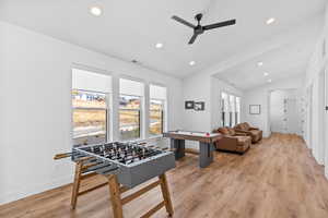 Recreation room with recessed lighting, light wood-type flooring, a ceiling fan, and lofted ceiling