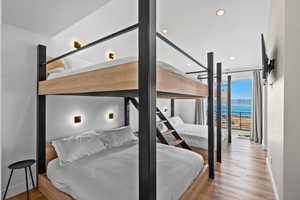 Bedroom with light wood-style floors and recessed lighting