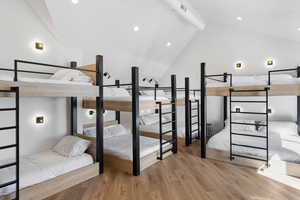 Bedroom featuring light wood-style floors, beamed ceiling, high vaulted ceiling, and recessed lighting