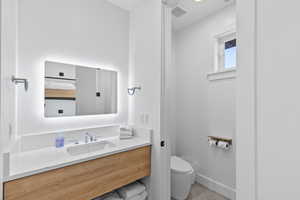 Half bath featuring vanity and toilet