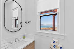 Half bathroom with vanity and a water view