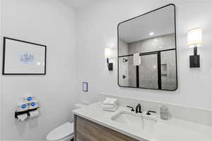 Bathroom with vanity and a stall shower