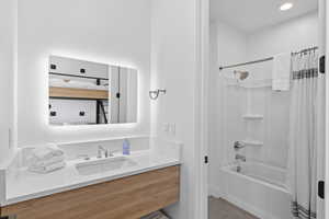 Full bathroom with shower / tub combo with curtain, vanity, light tile patterned flooring, and recessed lighting