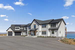 Modern inspired farmhouse featuring driveway and board and batten siding