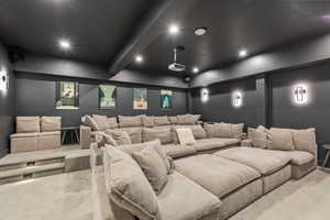 Carpeted home theater room featuring recessed lighting and beam ceiling